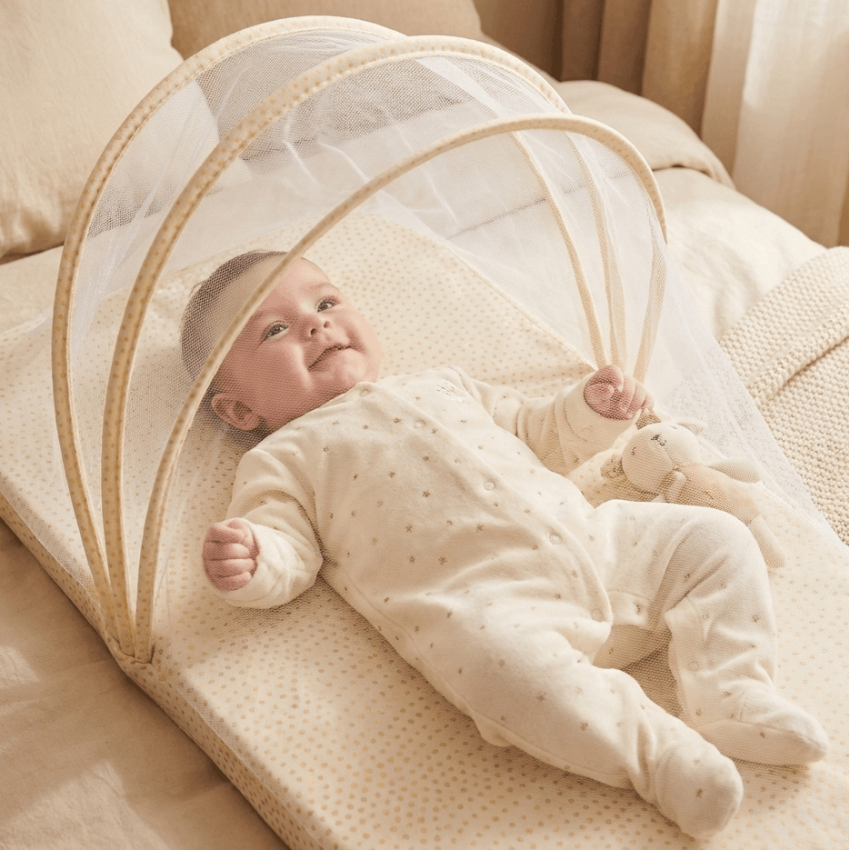 Baby lying in a beige baby mattress