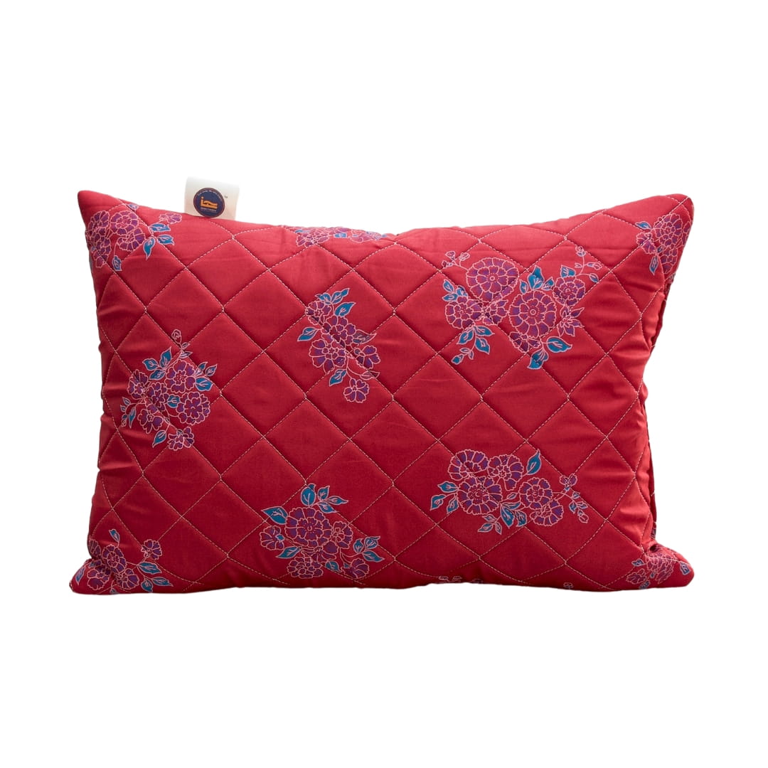 Red pillow with floral patterns on a white background