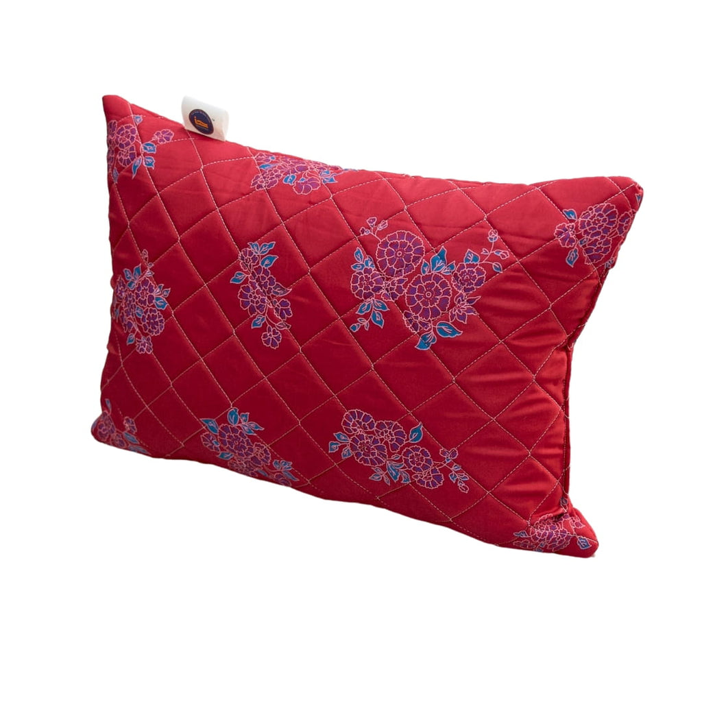 Red pillow with floral patterns on a white background