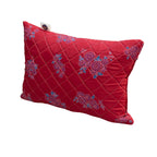 Red pillow with floral patterns on a white background