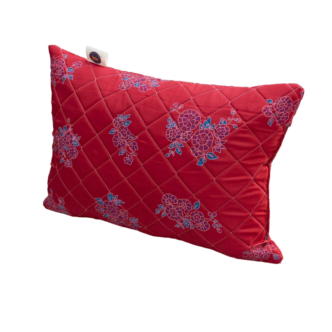 Red pillow with floral patterns on a white background
