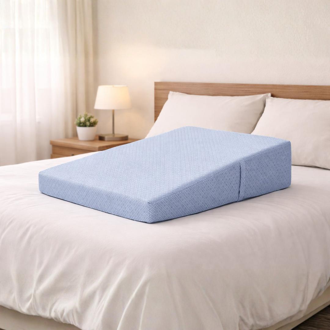 Blue wedge pillow on a bed in a bedroom setting